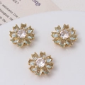 Three light blue crystal daisy spacer beads with gold settings and zircon centers - Light Blue
