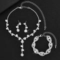 Sparkling bridal jewelry set with rhinestone necklace earrings and bracelet on black background - Silver White
