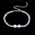 Close-up of double-row rhinestone bracelet with floral accents and lobster clasp closure - 838 Bracelet / Silver