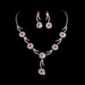 Elegant silver-tone jewelry set featuring red crystal floral necklace and matching earrings - Silver Base Red Stone