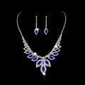 Elegant bridal jewelry set with navy blue marquise crystals and rhinestones on black background - Blue