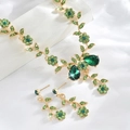 Detailed close-up of emerald green floral jewelry set with golden vine design - Gold Green (G230)