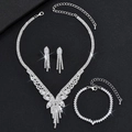 Macro shot of silver bridal jewelry set with sparkling crystals on black background - Intricate Silver 3-Piece Set