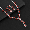 Detail of bridal jewelry set with V-shaped red rhinestone necklace and drop earrings - Silver Red Set