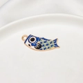 Makro-Detail des dunkelblauen und grünen Koinobori-Anhängers mit Goldlegierung - 12*34mm / Dunkelblau