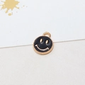 Detailed macro view of a round black and gold smiley face alloy charm pendant - 02# Black