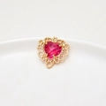 Macro shot of heart-shaped faux tourmaline pendant with gold-plated hollow lace border - Rose Red