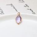 Macro shot of faceted purple diamond charm with gold plated copper edge for jewelry DIY - Light Purple