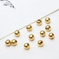 Macro detail of high-shine 18K gold plated round spacer beads for jewelry DIY making - Polished Ball / 4mm (ai-100 Pieces/Pack)