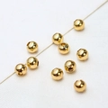 Detailed macro shot of high-polish 18K gold-plated spacer beads for DIY jewelry making - Polished Ball / 5mm (ai-100 Pieces/Pack)