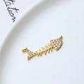 Macro detail of a gold-plated fishbone pendant with sparkling crystals and dual loops - Fishbone Style (01#)