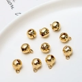 Close-up of 10 gold-plated bell pendants for DIY jewelry making and crafting - 8mm