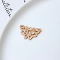 Detailed view of a gold butterfly charm with micro-paved zircons on a white ceramic plate - Full Rhinestone Butterfly Style (04#)