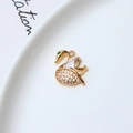 Macro detail of gold-plated swan pendant with white crystals and green eye stone - Swan Style (05#)