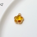Detail view of 12mm gold-plated flower charm with yellow faceted stone and beaded edge - Yellow