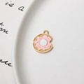 Close-up of pink enamel donut charm with gold metal edge on a white porcelain plate - Minimum 10 Pcs / Donut