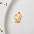 Detail of pink cupcake alloy pendant with heart decoration in a white ceramic dish - Minimum 10 Pcs / Cake
