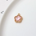 Close-up of a 12mm gold plated five-petal flower pendant with a light pink faceted stone - Pink