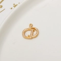 Macro shot of 18K gold plated brass D letter pendant with micro-pave white zircon - Flower Script Letter D Style (LF2389)