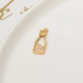 Macro detail of gold plated wishing bottle pendant with micro-paved white zircon stones - Micro Inlaid Zirconia Bottle Shape (LF2389)