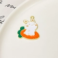 Macro view of cute enamel bunny on carrot charm with bright gold alloy edges for DIY jewelry - Carrot Rabbit