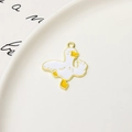 Detail of cute duck alloy charm with white and yellow enamel and golden outline - Little Duck