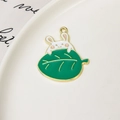 Detail of DIY white rabbit and green leaf enamel pendant for jewelry making - Rabbit With Leaf