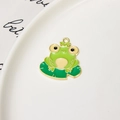 Detailed macro view of a cartoon frog on lotus leaf enamel charm with gold plating - Frog