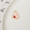 Detailed view of a pink strawberry milk box charm with gold plating for jewelry making - Pink Strawberry Milk Box