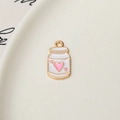 Close-up of alloy strawberry milk carton pendant with pink hearts for DIY jewelry - Pink Heart Decor Bottle