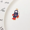 Detailed view of enamel astronaut pendant with blue space suit and golden plated finish - Astronaut 02 / Minimum 10 Pcs