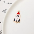 Detail of red and navy blue enamel rocket pendant with golden edges on white plate - Rocket 03 / Minimum 10 Pcs