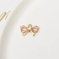 Detailed view of a gold bow pendant with sparkling crystal inlay for jewelry making - White Bowknot