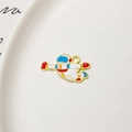 Detailed macro view of a gold-plated astronaut pendant with blue and white enamel for DIY jewelry - Astronaut 07