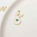 Macro shot of white rabbit enamel charm with green carrot on a ceramic plate - Holding Green Veggie (07#)