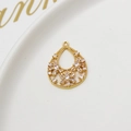 Macro shot of a hollow teardrop pendant with gold plating and white cubic zirconia crystals - Hollow Water Drop Style(02#)