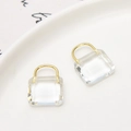 Macro shot of clear crystal handbag charms with gold metal handles on a white ceramic tray - Pendant Style (Pendant Only (Without Chain)) / White