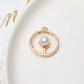 Detailed view of a gold geometric round pendant with a white pearl insert for DIY jewelry - Gold Round Style