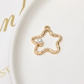 Macro shot of gold alloy star pendant with ripple texture and embedded pearl detail - Gold Star Style