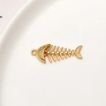 Macro detail of gold fish bone pendant with cubic zirconia for jewelry making - Fishbone Style