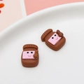 Miniature brown resin peanut butter jar charms with pink smiley labels on a ceramic plate - Peanut Butter Jar Shape (06#)