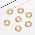 Close-up of golden snowflake spacer beads with milgrain edges for DIY jewelry making - 01# 7mm (Inner Diameter 3mm)