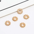Detailed view of five gold snowflake spacers for DIY jewelry making and beading - 02# 5.5mm (Inner Diameter 2mm)