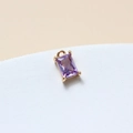 Macro shot of a purple rectangular glass pendant with a gold setting and bail for jewelry - Light Purple