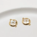 Detailed view of brass gold-plated four-leaf clover charms with white mother-of-pearl inlay - 17#12*16mm