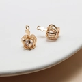 Macro detail of two crown-shaped gold pendants with cubic zirconia inlay on a ceramic tray - 10+ / Gold (03#) Cross Crown
