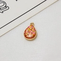 Macro view of gold-plated teardrop pendant with sparkling glitter for DIY jewelry making - Red