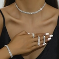 Close-up of elegant rhinestone jewelry set with wave pattern worn by female model - Silver Necklace Earrings Bracelet Ring