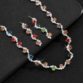 Close-up of bridal jewelry set with colorful rhinestones on a textured black surface - Multicolor (Necklace Earrings Set)
