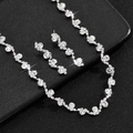 Close-up of wavy silver-plated bridal necklace and earring set with sparkling rhinestones - White (Necklace Earrings Set)
